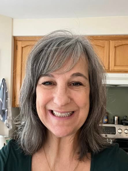 Emily P. smiling with her grandson